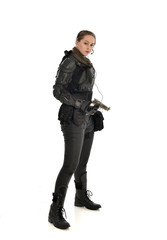 Fototapeta premium full length portrait of female soldier wearing black tactical armour, holding a gun, isolated on white studio background.