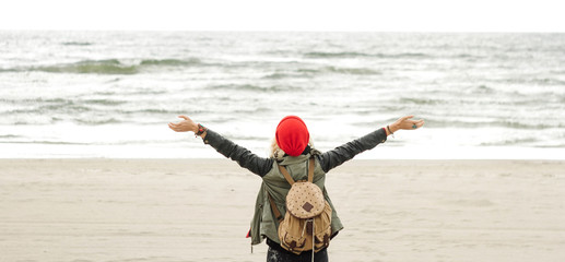 Back view of female enjoying beach