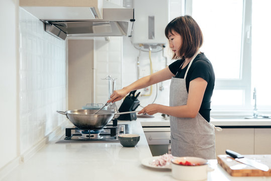 Young woman cooking in kitchen