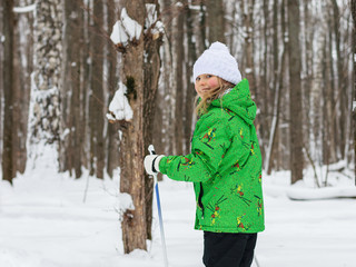 Girl on skis in the woods. Training. Winter sports.
