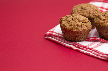 Apple Cinnamon Pecan Muffins on an Apple Red Background