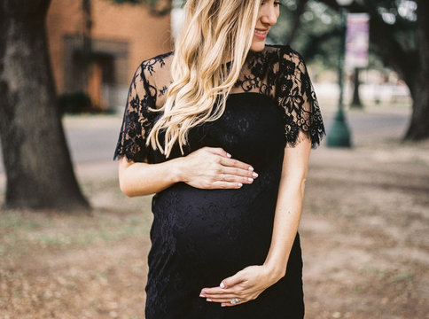 A beautiful woman holding her belly - expecting / pregnant