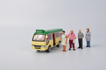Miniature travellers at a busy bus station