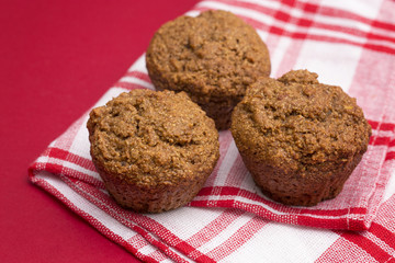 Apple Cinnamon Pecan Muffins on an Apple Red Background