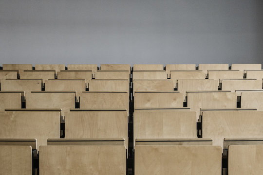 Desks in an empty lecture hall