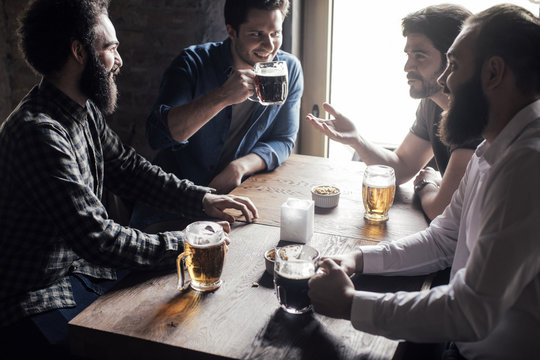 Friends Drinking Beer at Pub