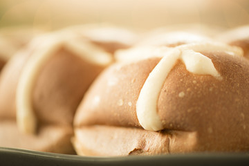 Tasty traditional Easter hot cross buns, closeup view.
