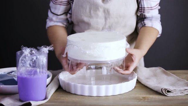 Step by step. Pastre shef glazing mousse cake with purple mirror glaze