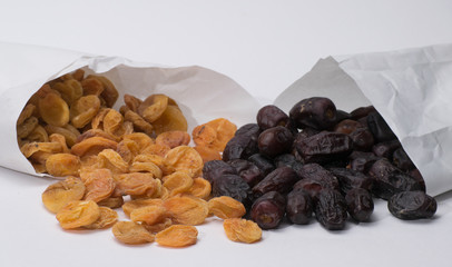 dried apricots and dates in a paper bag