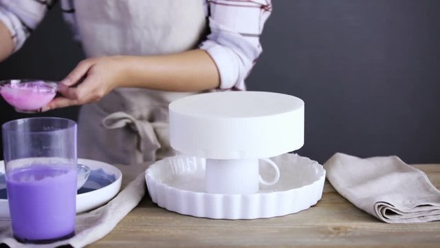 Step by step. Pastre shef glazing mousse cake with purple mirror glaze