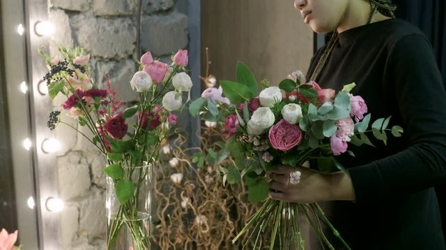 Florist woman making a bouquet of fresh beautiful flowers. 4K