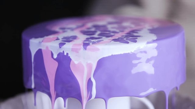 Step by step. Pastre shef glazing mousse cake with purple mirror glaze
