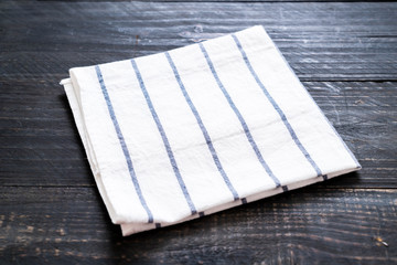 kitchen cloth (napkin) on wood background