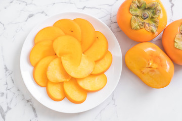 sliced persimmon on plate