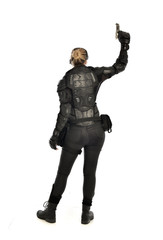 full length portrait of female  soldier wearing black  tactical armour, holding a gun, isolated on white studio background.