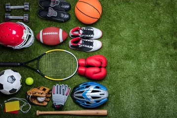 Zelfklevend Fotobehang Various Sport Equipments On Grass © Andrey Popov