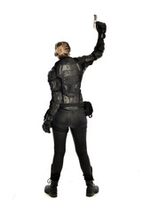 full length portrait of female  soldier wearing black  tactical armour, holding a gun, isolated on white studio background.
