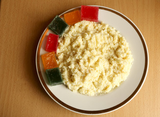 useful breakfast. wheat porridge with marmalade. golden gruel from millet with pieces of fresh fruit jelly.