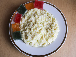 useful breakfast. wheat porridge with marmalade. golden gruel from millet with pieces of fresh fruit jelly.