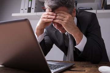 Upset Businessman Sitting In Office