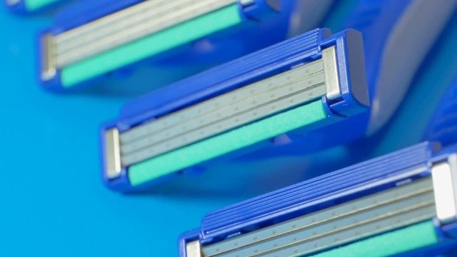 Disposable blue razors closeup. Smooth rotation.