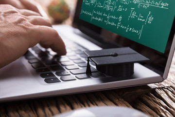 Student Solving Mathematical Problems On Laptop