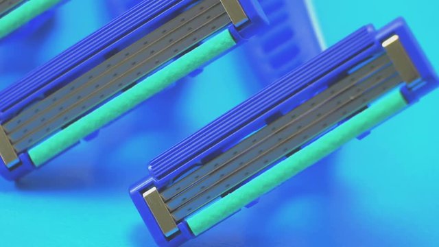 Disposable blue razors closeup. Smooth rotation.
