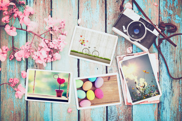 Retro camera and paper photo album on wood table with flowers border design - concept of...