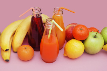 Juice Glasses of freshly Fruit juice with colorful fruits on Pink Background. Banner. Healthy Food Concept.