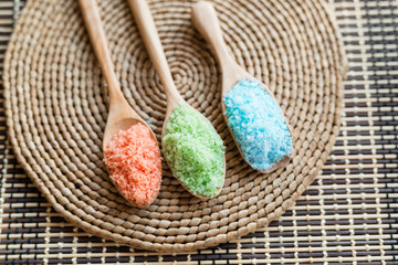 Beautiful spa composition with salt in spoon wooden on mat background. top view