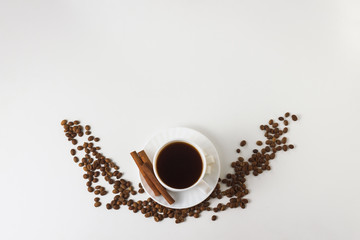 White cup with coffee, coffee beans on a white background. Flat lay, top view