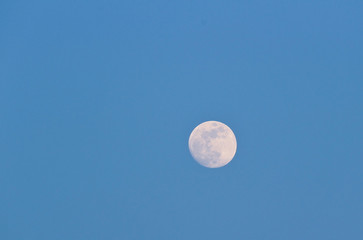 Full moon on clear blue winter sky