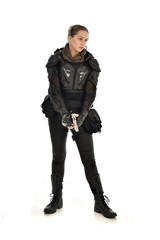 full length portrait of female  soldier wearing black  tactical armour, holding a gun, isolated on white studio background.
