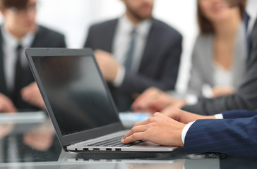 Hands of business man working on laptop.