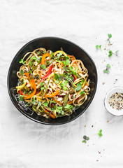 Pad Thai vegetarian vegetables udon noodles in a light background, top view. Vegetarian food in asian style