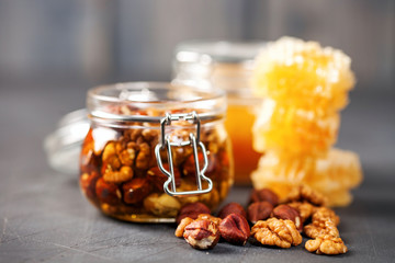 A honey jar with a nuts