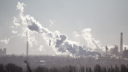 Smoke from the pipes of an industrial plant in the morning