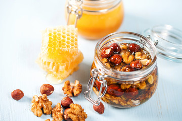 A honey jar with a nuts