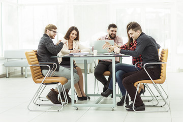 business team discussing work documents sitting behind a Desk