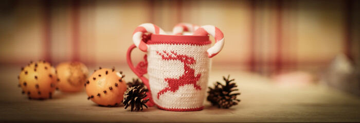 Christmas Cup and oranges on wooden background blurred.