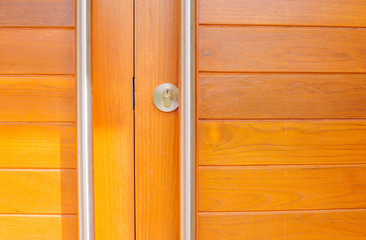 Fototapeta premium Modern wooden doors and door handles are made of stainless steel with sunshine in the morning. Vintage Style