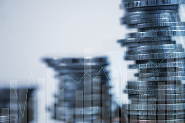 Double exposure Stack of coin with financial graph over city and office building background, business and financial concept.