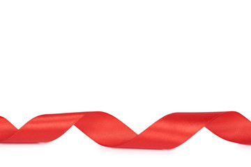 Red silk swirled ribbon. Isolated on white background. Copy space