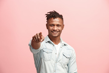 The happy businessman point you and want you, half length closeup portrait on pink background.