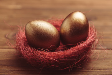 gold eggs on wooden table