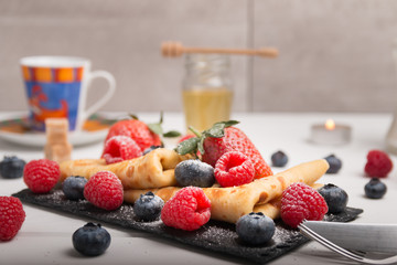 pancakes with fresh fruits, strawberry, raspberry, honey and coffee