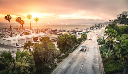 Aerial panoramic view of Ocean Ave freeway in Santa Monica beach at sunset - City streets of Los Angeles and California state surrounds - Warm twilight color filter tones with dark vignetting © Mirko Vitali