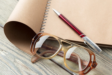 notepad and eyeglasses on the table