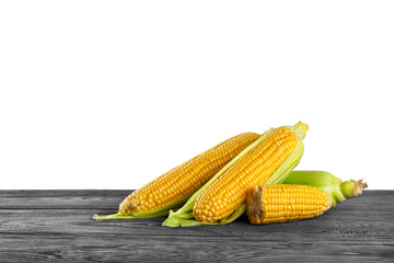 Pile of ripe corn on wooden table
