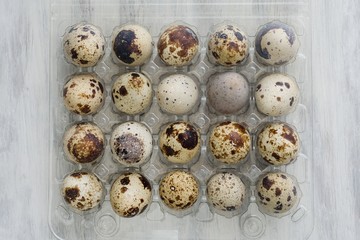 Fototapeta premium Pack of 20 quail eggs on white vintage background